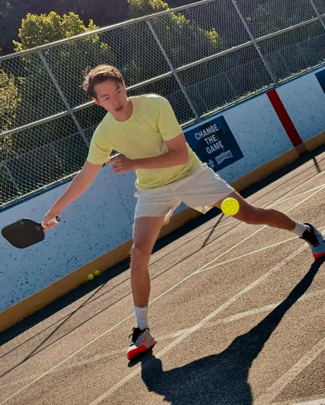 A player chasing down a shot on the outdoor courts