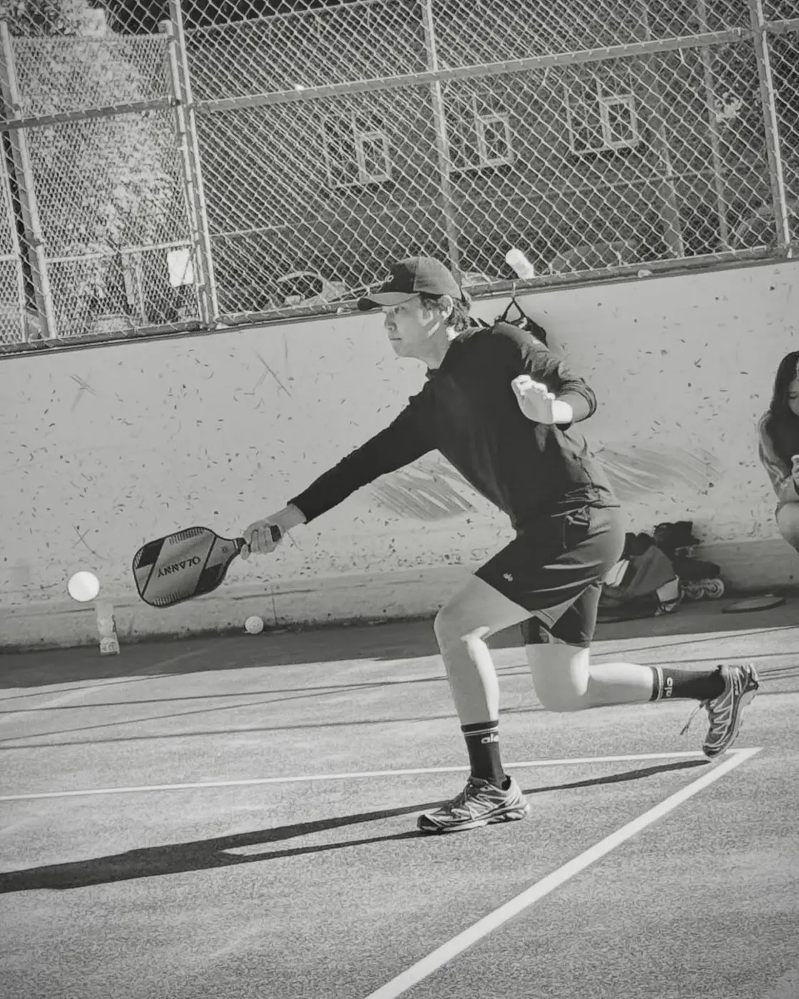 A player rising into a serve on court